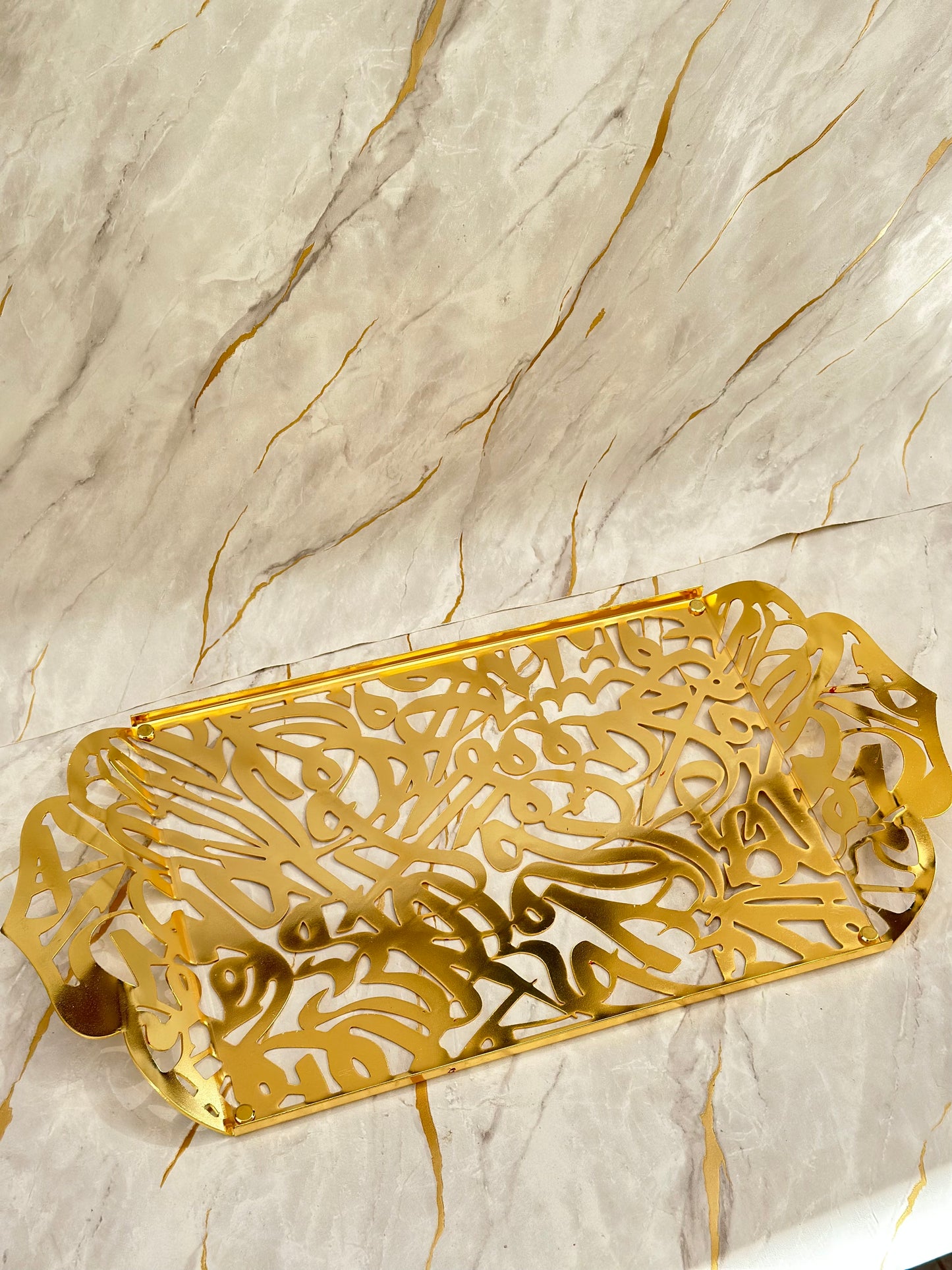 "Experience the artistry of our Andalusia Golden Tray, meticulously crafted from aluminum and acrylic, adorned with elegant Arabic calligraphy. This long tray combines modern materials with traditional design, perfect for serving or as a decorative centerpiece."