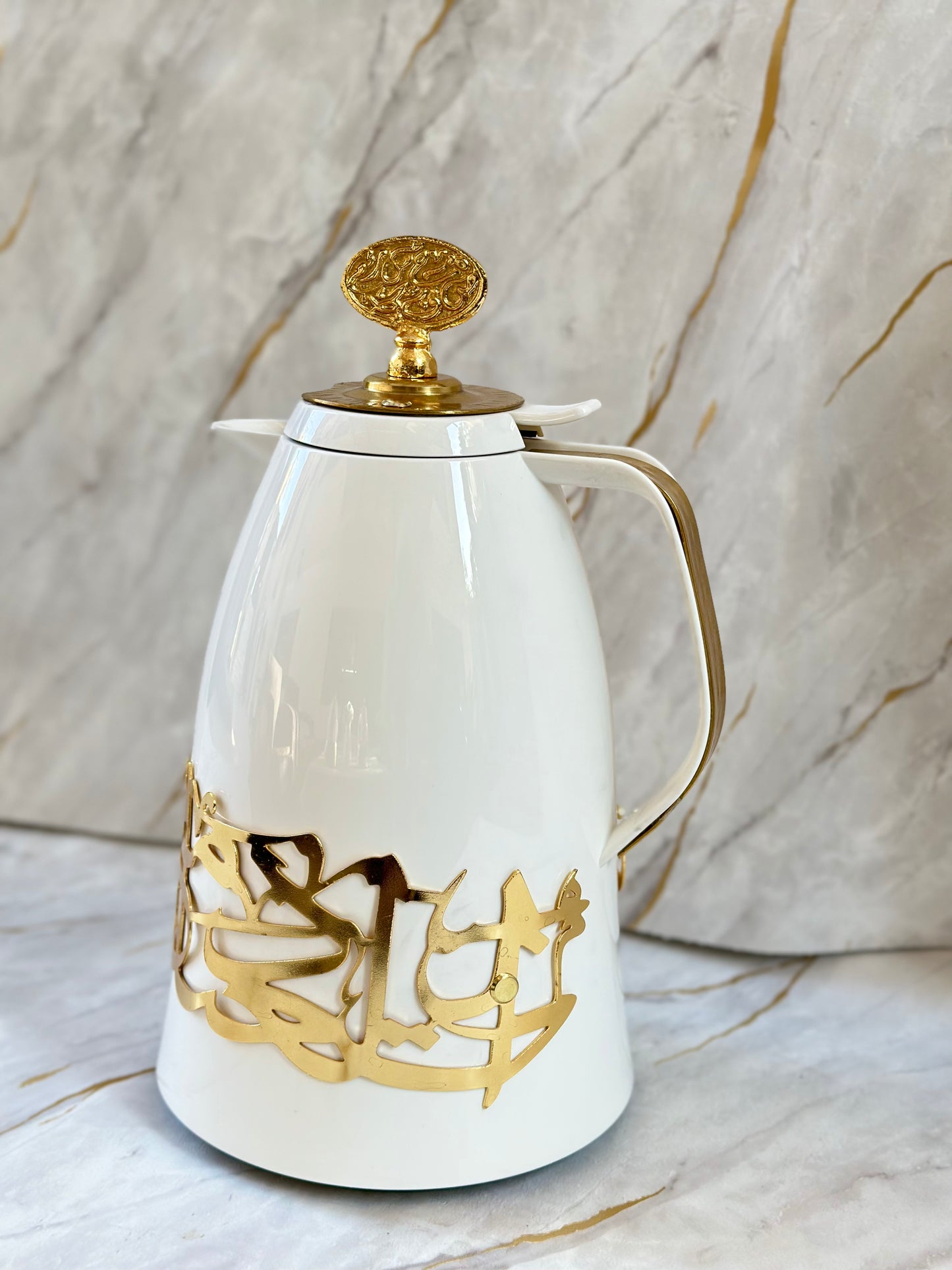 Discover the Arabesque Coffee Flask, crafted with meticulous German engineering and adorned in gold accents. This stunning flask combines modern design with traditional Arabic calligraphy, ensuring your coffee stays warm for hours. Ideal for those who appreciate both style and practicality, it's a statement piece that brings sophistication to any coffee ritual or makes a memorable gift showcasing craftsmanship and cultural elegance.