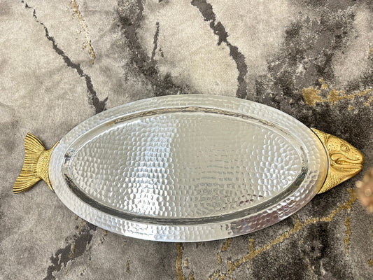 Meet our Fish-Shaped Serving Platter, a whimsical delight crafted from hammered glass with a metallic gold fish head and tail. Ideal for serving appetizers or as a decorative accent, it sparkles under light, adding nautical charm to your gatherings. Perfect for hosts who appreciate unique, ocean-inspired decor!