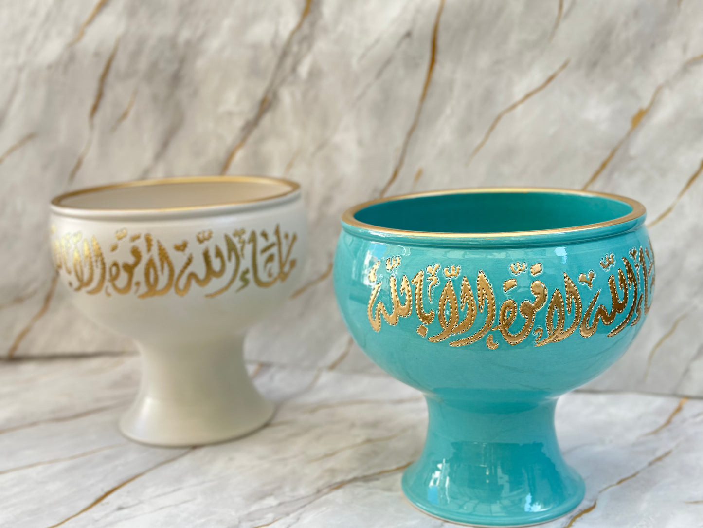 Discover our Ceramic Pedestal Bowls, a harmonious blend of luxury and heritage. Featuring striking Arabic calligraphy in rich gold, available in vibrant turquoise or serene cream, these bowls are perfect for adding a touch of divine elegance to any room.