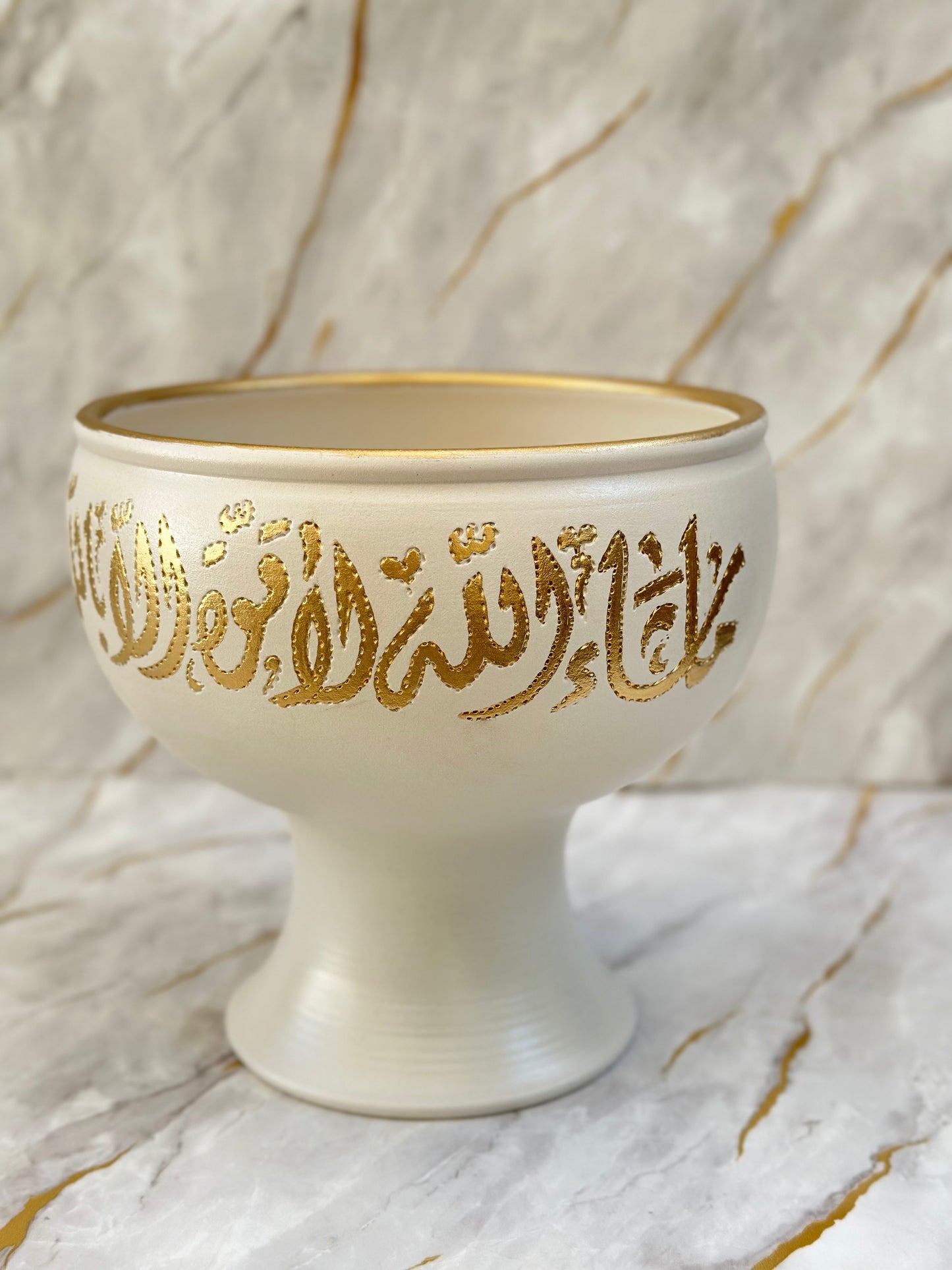 Our Ceramic Pedestal Bowls blend tradition with sophistication, featuring exquisite Arabic calligraphy in gleaming gold. Available in vibrant turquoise or serene cream, these bowls are ideal as decorative pieces or unique gifts for special occasions.