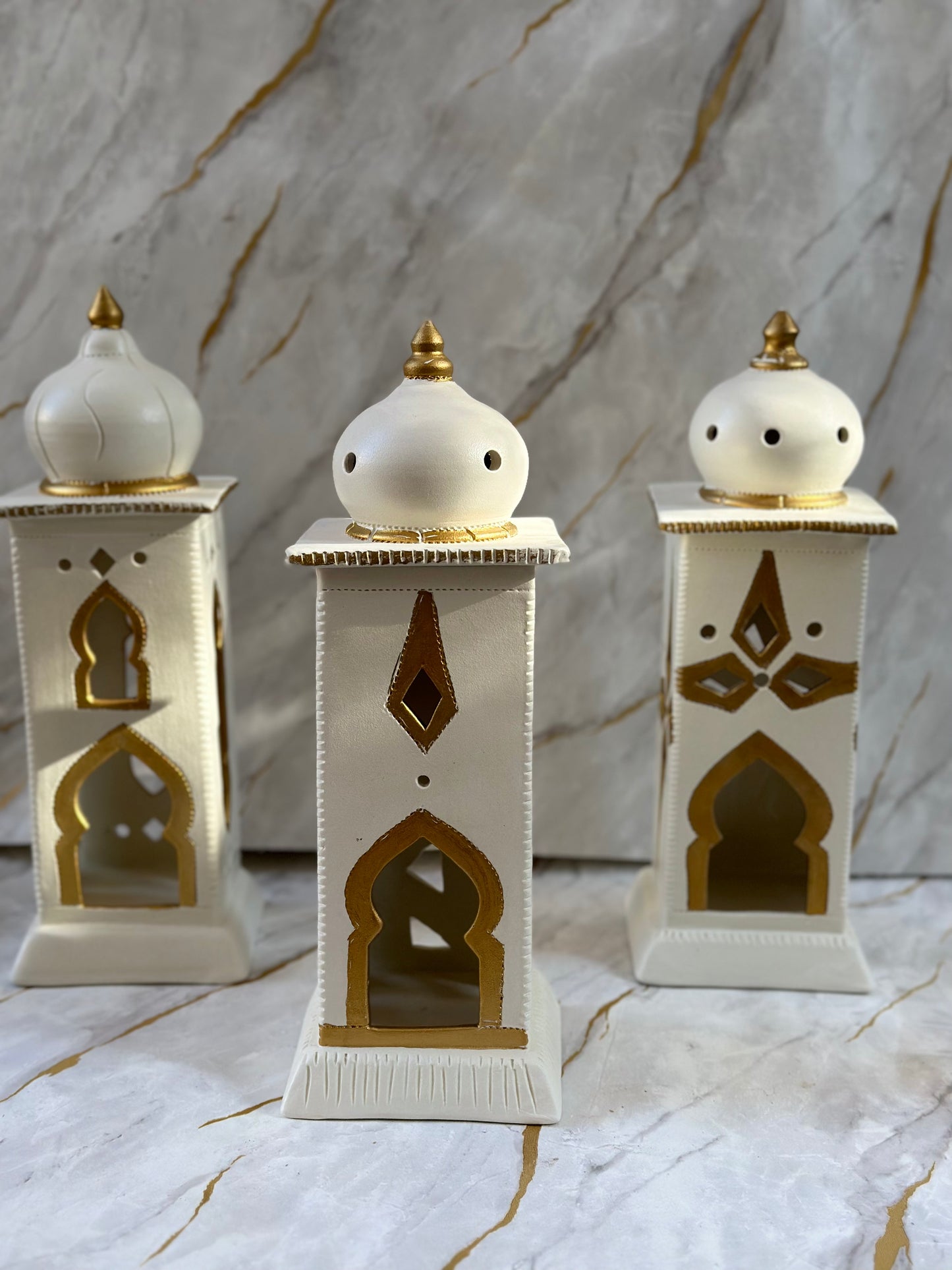 Mark Ramadan with our Ceramic Minaret, crafted in cream and turquoise with intricate golden accents. Ideal for diffusing incense or holding electric candles, its elegant design adds a touch of spirituality to your living space.