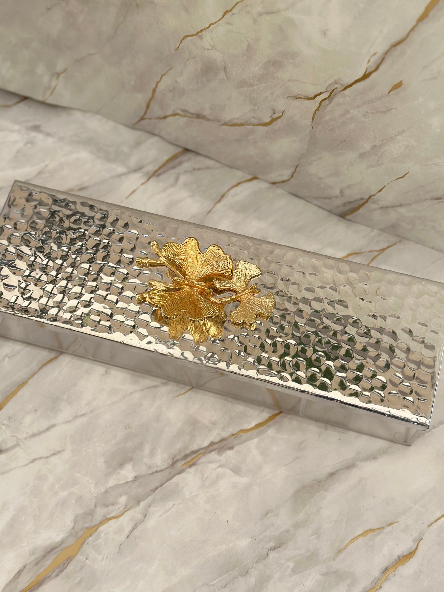 Discover the allure of our Arabesque Metal Tray for chocolates and nuts. With a segmented mirrored base and a stunning golden floral accent, this piece marries aesthetic appeal with practicality. Ideal for adding a touch of luxury to your entertaining space.