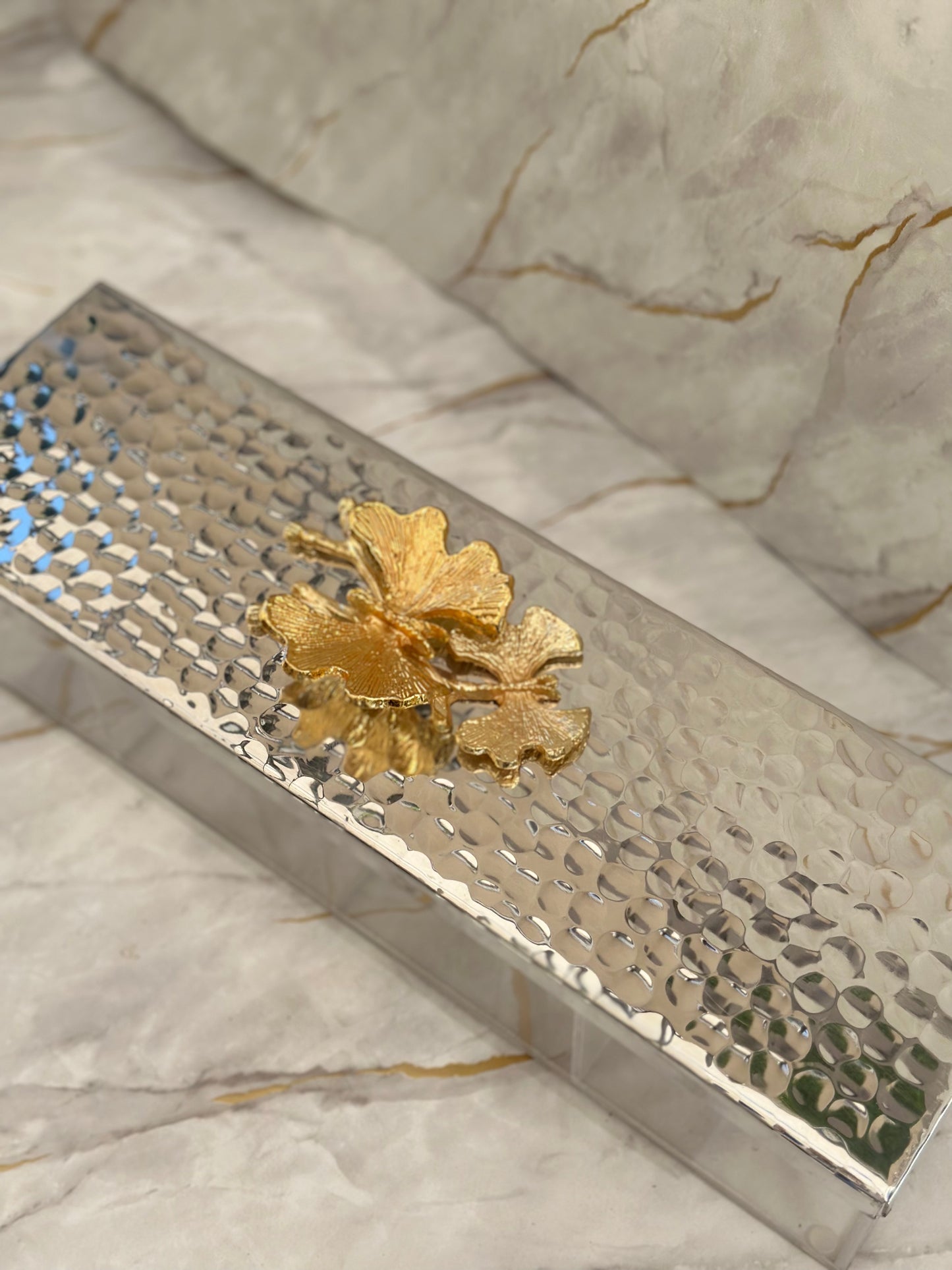 Impress guests with our Divided Arabesque Metal Tray. Crafted with a mirrored base and exquisite golden floral detail, it combines beauty with functionality. Supported by clear acrylic legs, this tray is perfect for serving chocolates and nuts with style and sophistication.