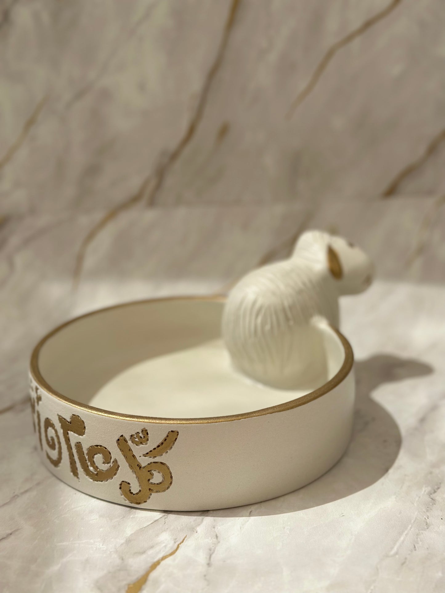 Discover the Ceramic Sheep Bowl, where artistry meets functionality. Its artisanal ceramic design, adorned with a golden rim and a cute lamb figure, makes it perfect for serving snacks or holding trinkets. A versatile addition to your decor, ideal for both practical use and aesthetic appeal.