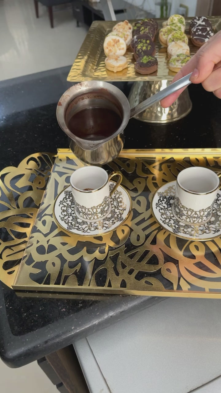 "Add a touch of elegance to your living space with the Andalusia Golden Mirror Tray, expertly fashioned from aluminum and acrylic. Adorned with Arabic calligraphy in gold, this long tray offers versatility as a serving essential or as a stunning decorative accent."