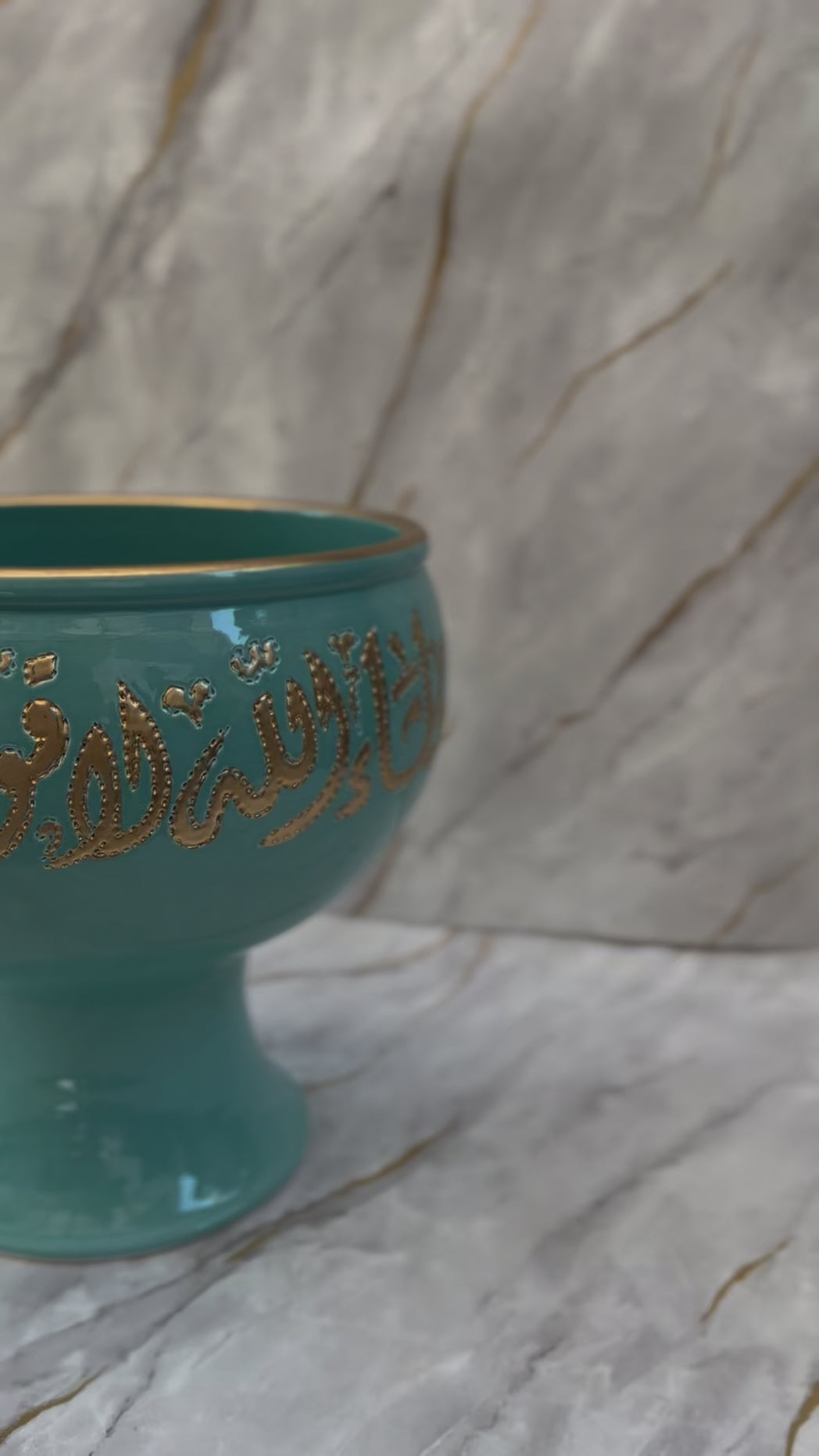 Create an ambiance of grace with our Ceramic Pedestal Bowls, showcasing opulent gold Arabic calligraphy - لا اله الا الله محمد رسول الله. Choose from vibrant turquoise or serene cream to complement your decor, perfect for adding cultural richness to any setting.