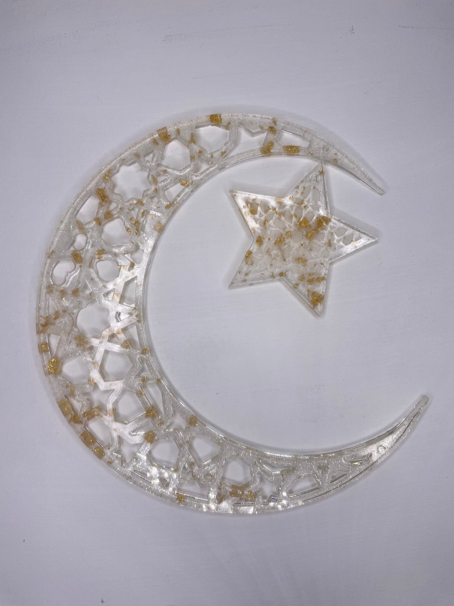 Celebrate Ramadan with our customizable Crescent Moon & Star Wall Decor. Handcrafted from resin, each piece embodies spiritual serenity and peace. Perfect for Ramadan decorations, it features intricate Islamic calligraphy, customizable colors, and symbolic crescent and star designs. Enhance your home with this unique 3D contemporary wall art, reflecting the essence of Ramadan. Ideal for those seeking modern Islamic wall art to beautify their living spaces during this auspicious time.